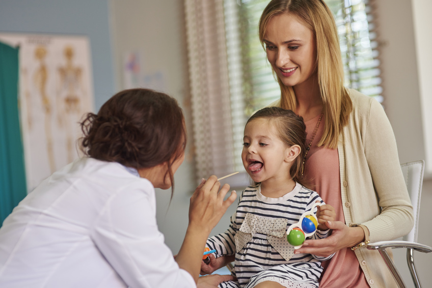 Routine examination of little girl's throat